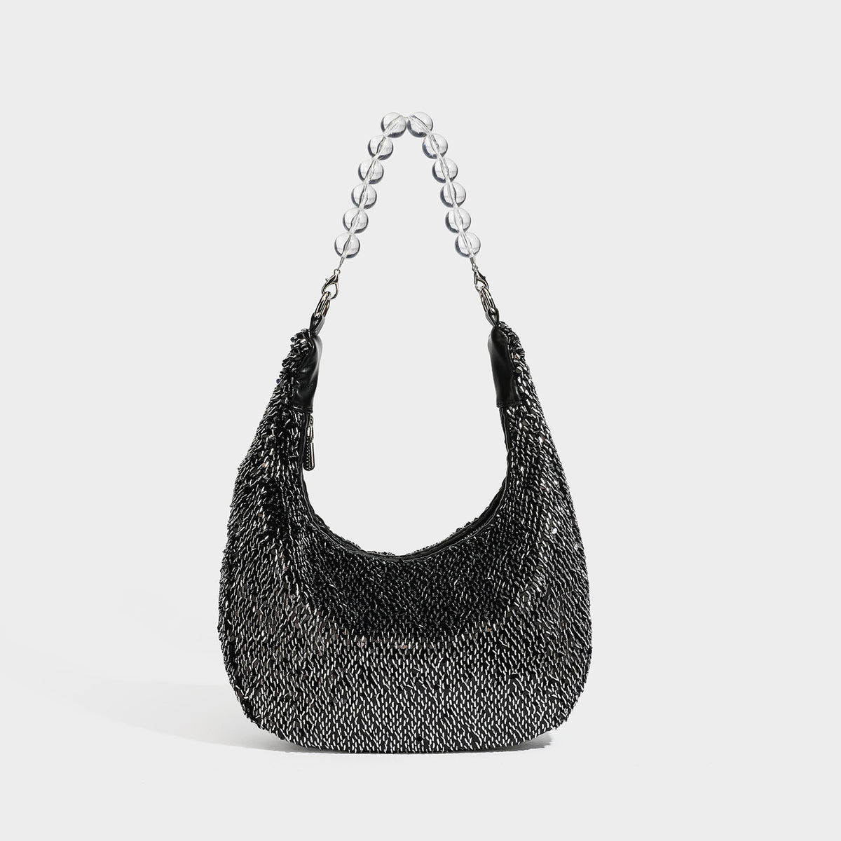 Kleine sichelförmige Schultertasche mit rundum silberfarbenem Paillettenbesatz, transparentem kugelförmigem Perlen-Tragegriff und silberfarbenem Reißverschluss