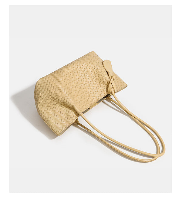 Woven leather-look tote bag in yellow with long shoulder straps, heart-shaped hanging charm, and removable inner zip pouch