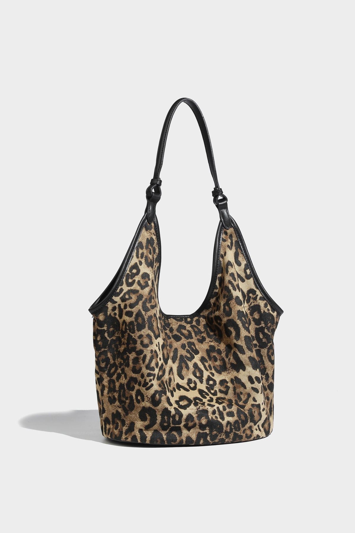 Slouchy brown leopard jacquard hobo tote bag with black leather-look trim and single shoulder strap, shown with black, detail