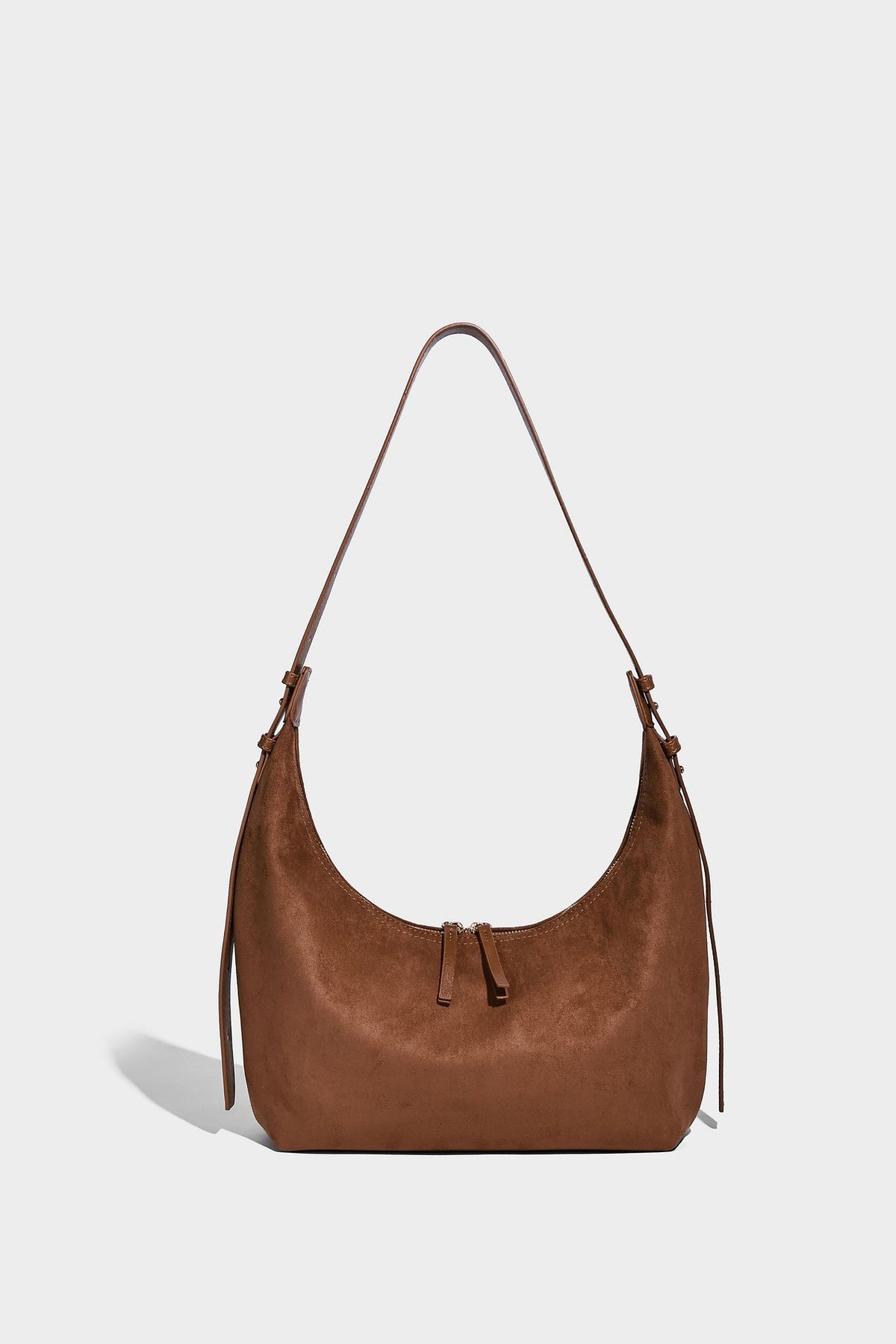Slouchy crescent hobo shoulder bag in dark chocolate matte suede-look finish with adjustable strap and twin-pull top zip