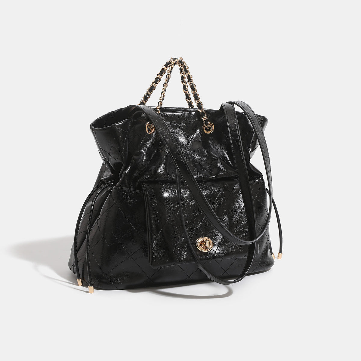 Black glossy diamond-quilted bucket tote bag with gold-tone chain accent, turn-lock front flap pocket, drawstring side ties