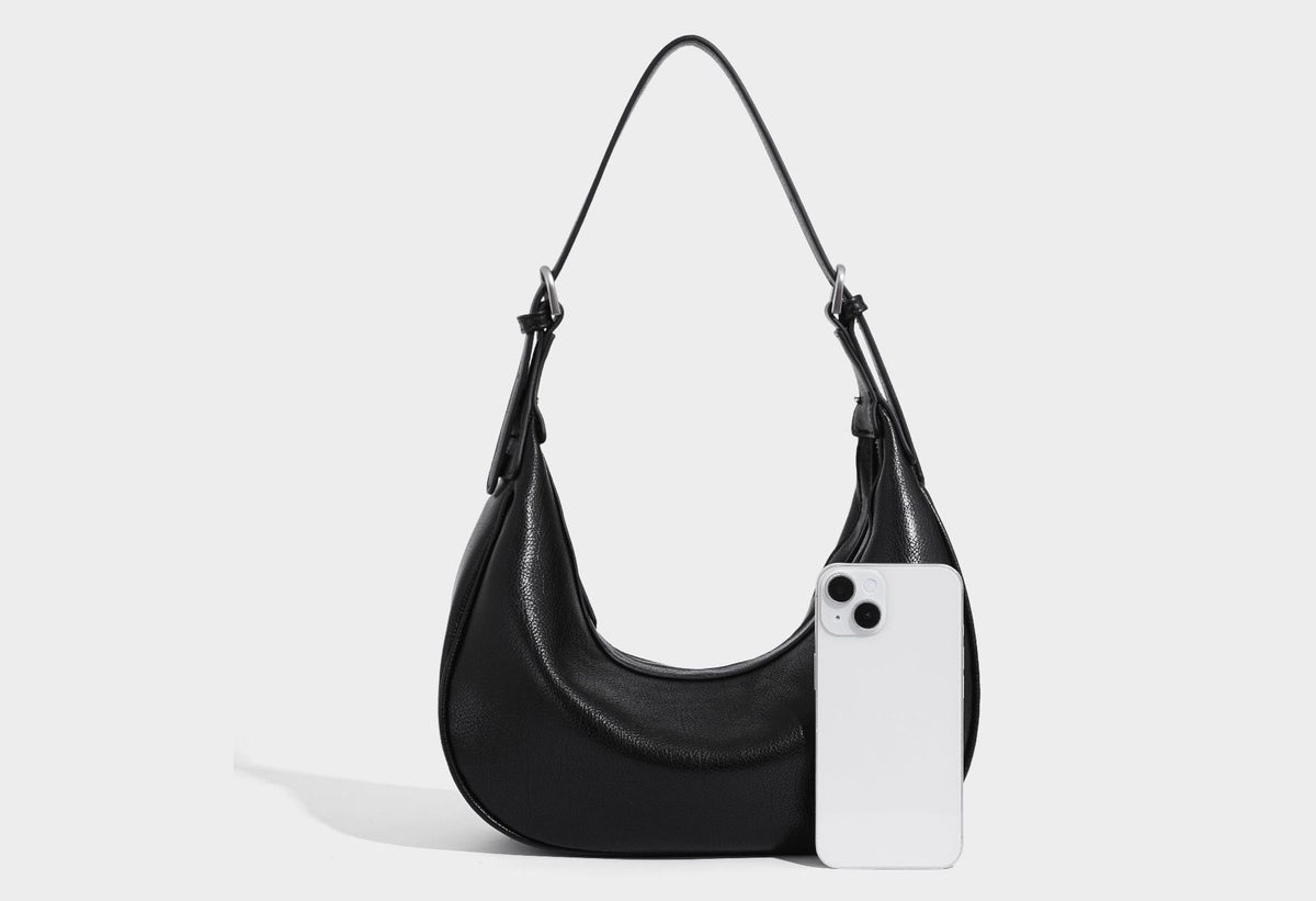 Crescent half-moon shoulder bag in pebbled leather-look finish with adjustable strap and silver-tone hardware, detail view 18
