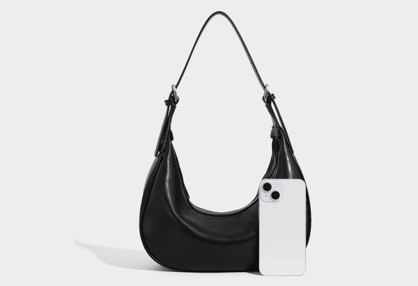 Crescent half-moon shoulder bag in pebbled leather-look finish with adjustable strap and silver-tone hardware, detail view 18