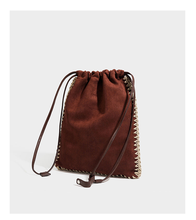 Matte suede-look drawstring bucket bag with cream braided woven edge trim and slim adjustable leather-look shoulder strap