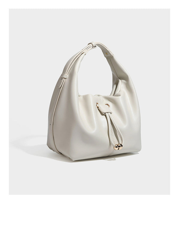 Slouchy hobo bag with smooth leather-look finish, drawstring cinch closure, and gold-tone bead hardware, detail view 18