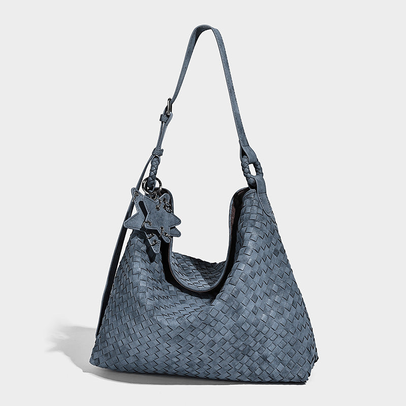 Large soft woven hobo shoulder bag with matte textured finish, adjustable strap, and star charm hardware, detail view 3