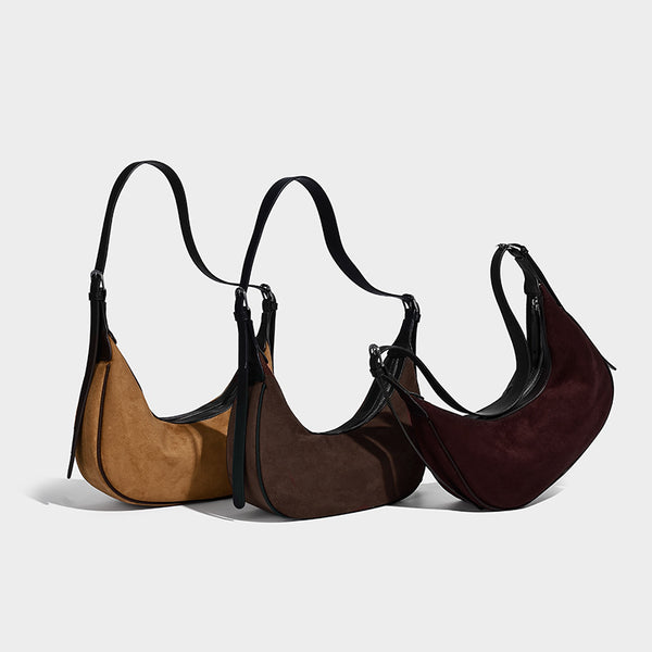 Crescent hobo shoulder bag in matte suede-look finish with black trim and adjustable strap, detail view 2