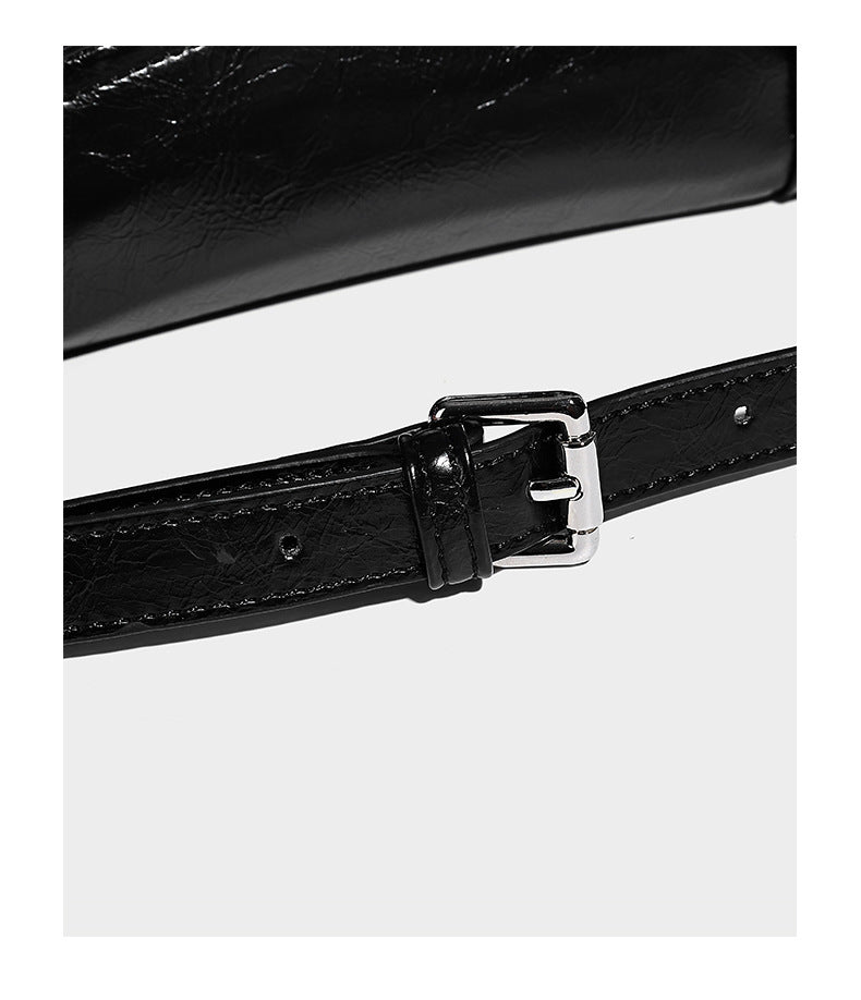 Glossy structured black tote shoulder bag with silver buckle hardware, zip pockets, dual top handles, and detachable, detail