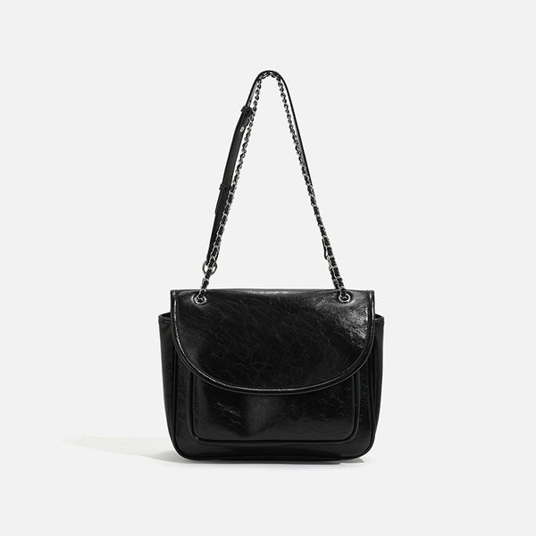 Structured glossy leather-look flap crossbody satchel with woven chain-and-leather shoulder strap, detail view 7