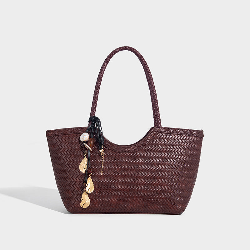 Large open-top woven tote bag with contrasting braided double handles and matching drawstring pouch, detail view 6