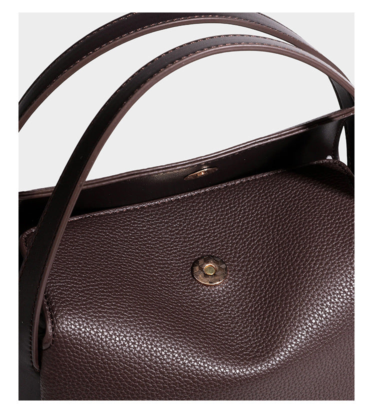 Structured pebbled leather-look shoulder bag with flap top, gold-tone emblem hardware, dual top handles, and detachable