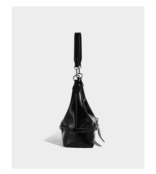 Glossy black slouchy hobo shoulder bag with silver-tone hardware, belt-style grommet strap at base, and long adjustable