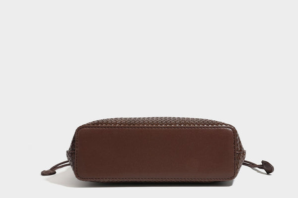 Structured woven leather-look tote bag in dark brown with long shoulder straps, side drawstring ties, and gold filigree