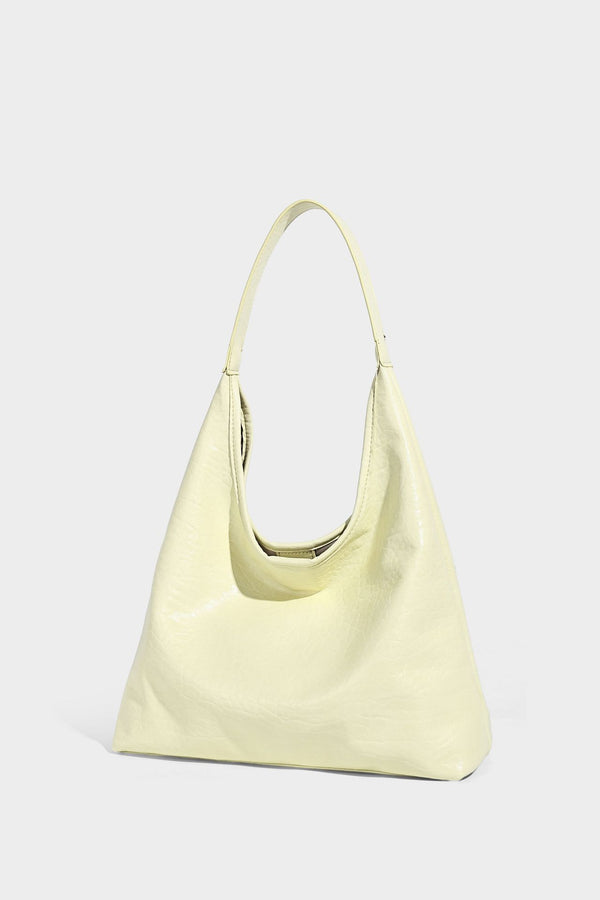 Slouchy hobo shoulder bag in pale yellow glossy pebbled leather-look finish with single shoulder strap and detachable front