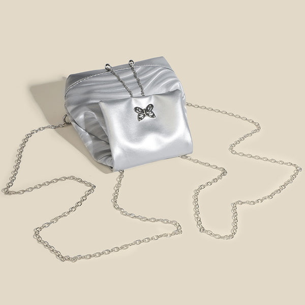 Compact ripple-embossed leather-look backpack handbag with silver butterfly clasp and chain straps, detail view 4