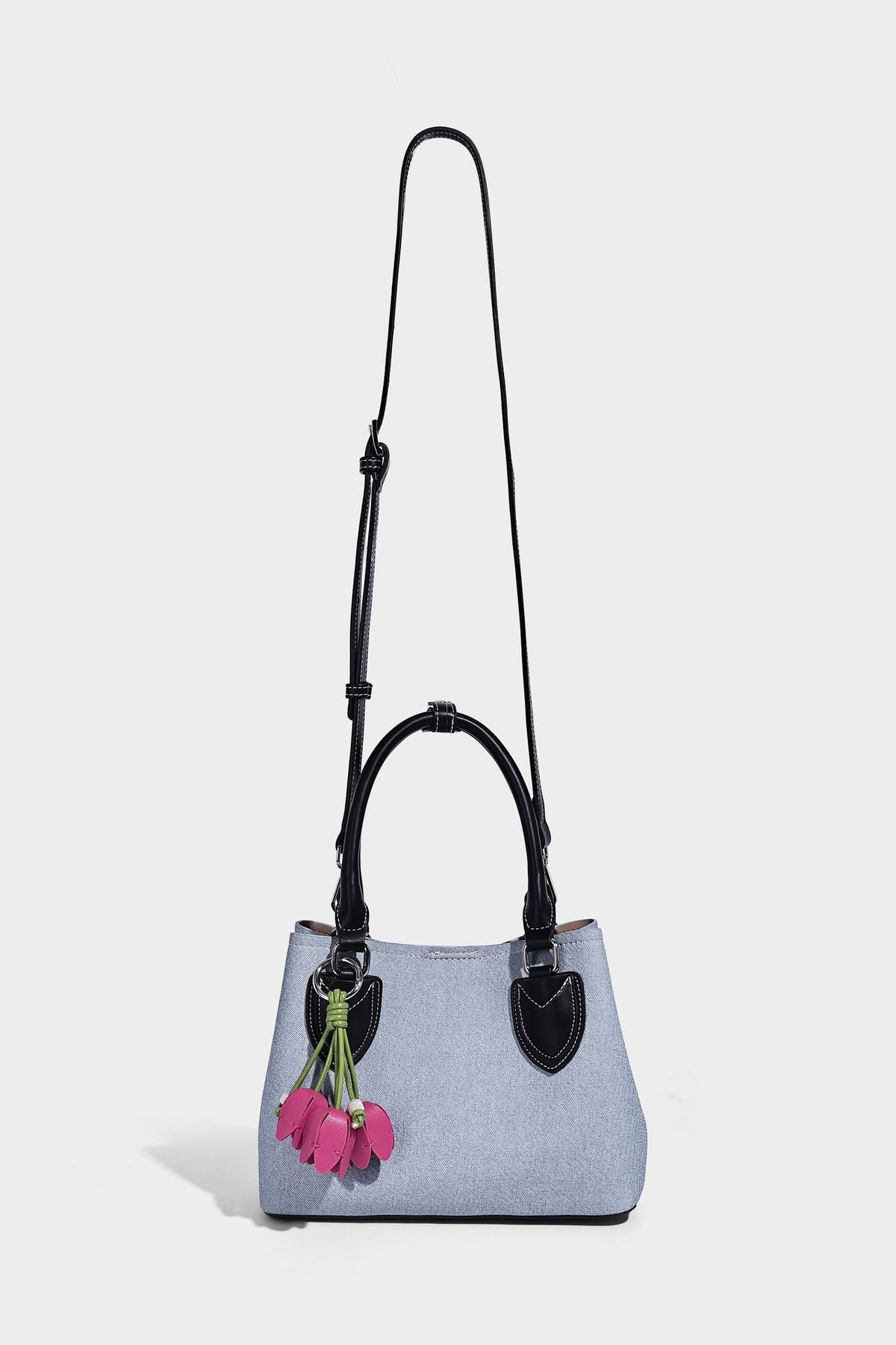 Structured light-blue denim-look tote bag with black leather-look handles, white contrast stitching, silver-tone hardware