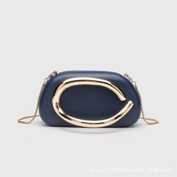 Kleine rechteckige Crossbody-Clutch mit abgerundeten Ecken, oversized poliertem C-förmigem Goldgriff und schmalem Goldkettenriemen, Detailansicht
