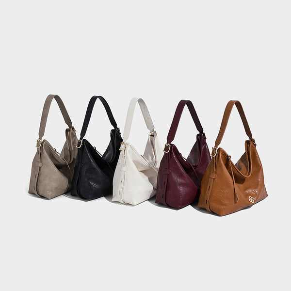 Slouchy leather-look hobo shoulder bag with gold-tone hardware and adjustable strap in brown, detail view 2