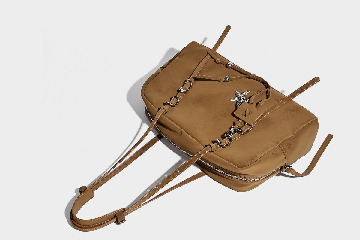 Structured rectangular matte suede-like shoulder bag with silver-tone hardware, zip closure, double top handles, and, detail