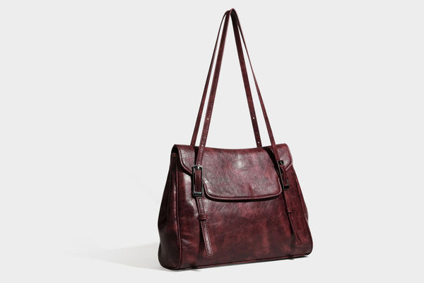 Structured flap-top shoulder tote bag in distressed leather-look finish with silver-tone buckle hardware and double shoulder