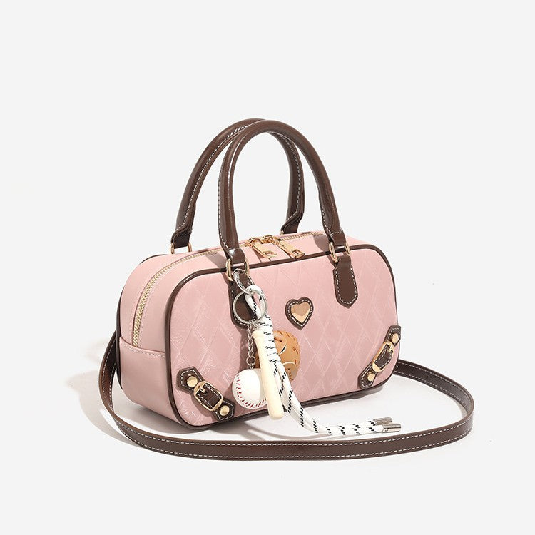 Small structured blush pink quilted diamond Boston barrel bag with brown leather-look trim, double top handles, heart accent