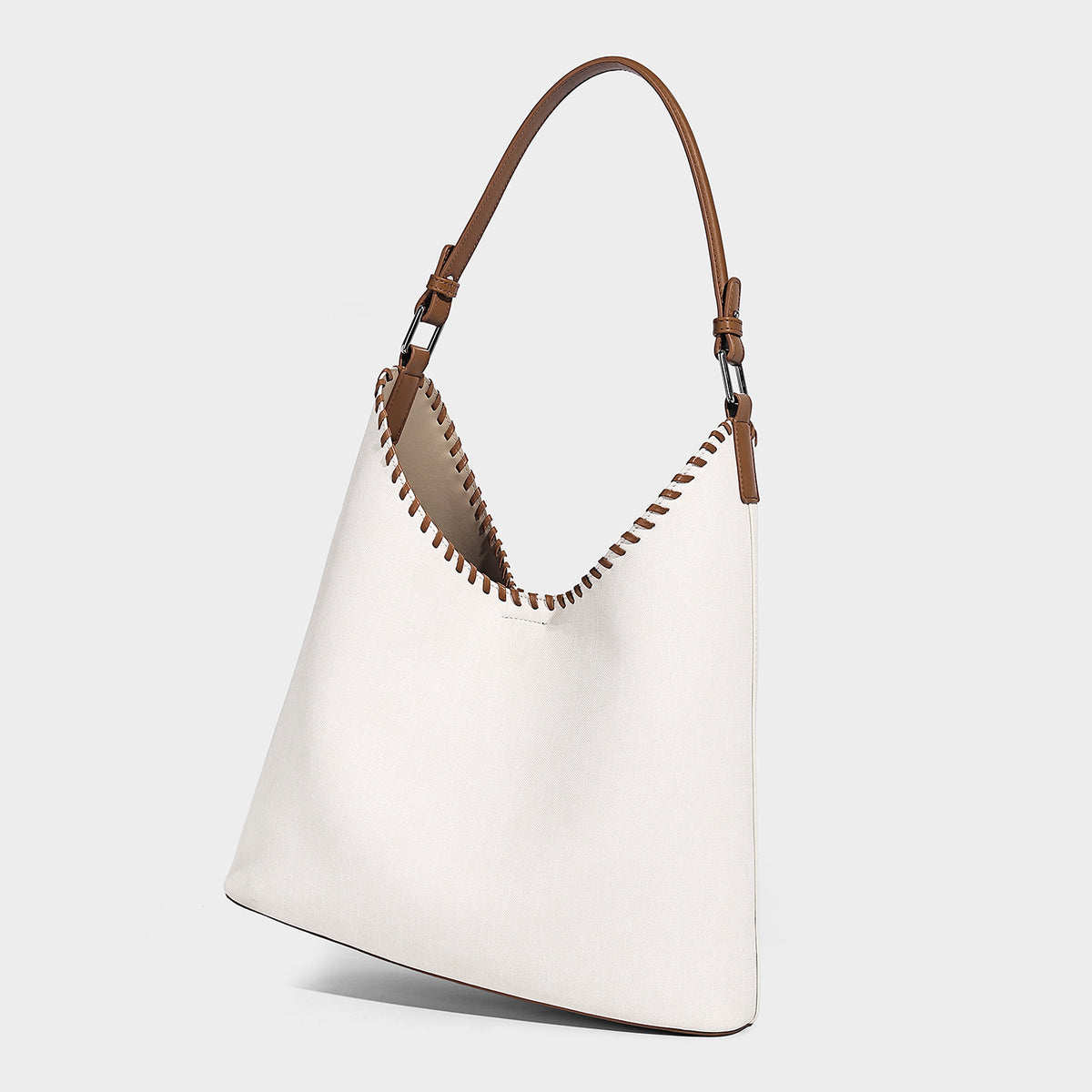 Denim-blue hobo tote with white leather-look shoulder strap, contrast whipstitch trim along curved open top, and silver-tone