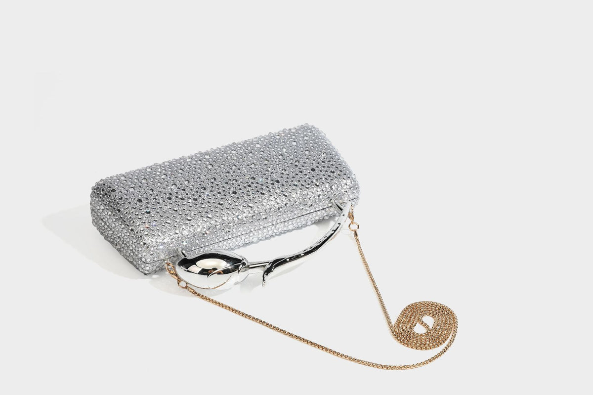 rectangular hard-case rhinestone evening clutch with sculptural gold-tone branch-and-bud top handle and detachable chain