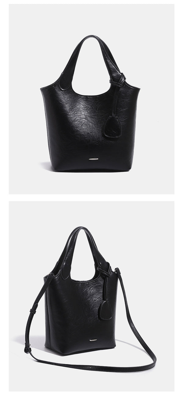 Soft glossy leather-look bucket tote bag with twin handles and detachable crossbody strap, detail view 9