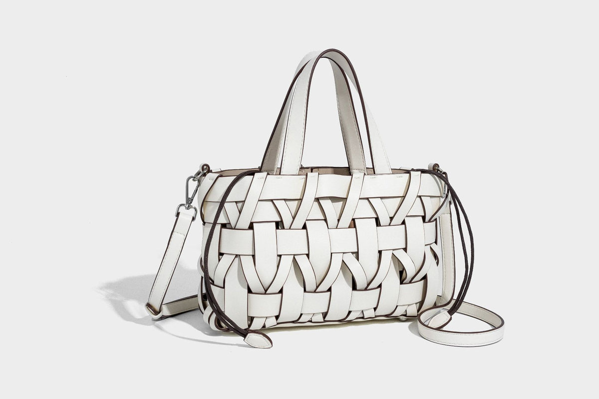Structured woven basket tote handbag with contrasting dark trim, double top handles, detachable shoulder strap, and