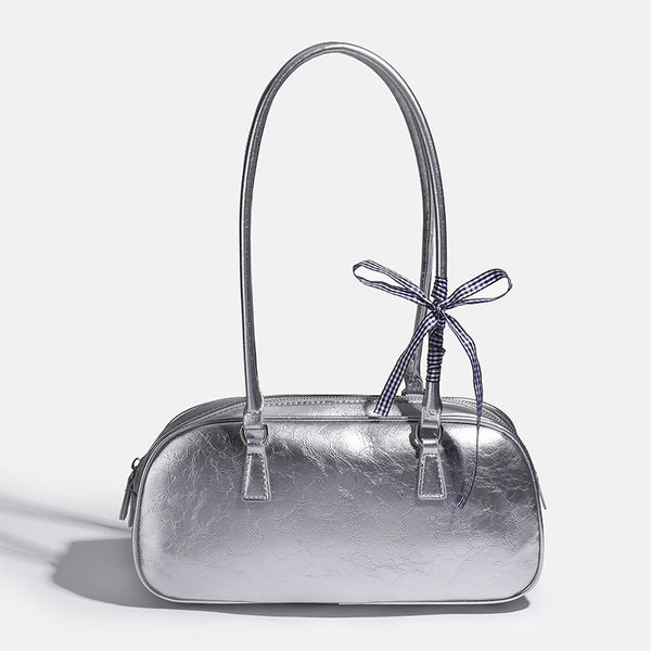 Rounded rectangular shoulder bag with glossy crinkled finish, dual long handles, top zip closure, and gingham ribbon bow