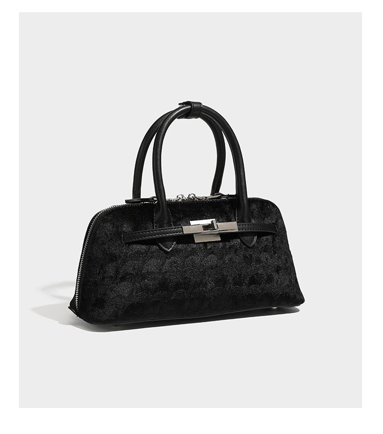 Small structured satchel bag in dark brown velvet-like textured finish with leather-look trim, silver-tone turn-lock bar