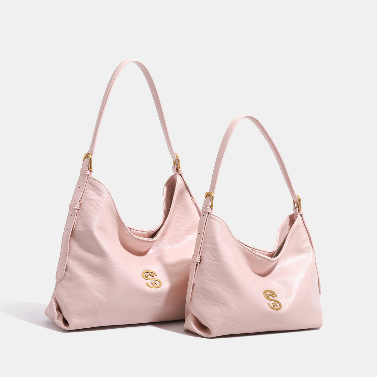 Soft slouchy hobo shoulder bag with glossy leather-look finish, gold-tone logo hardware, and adjustable strap, detail view 2