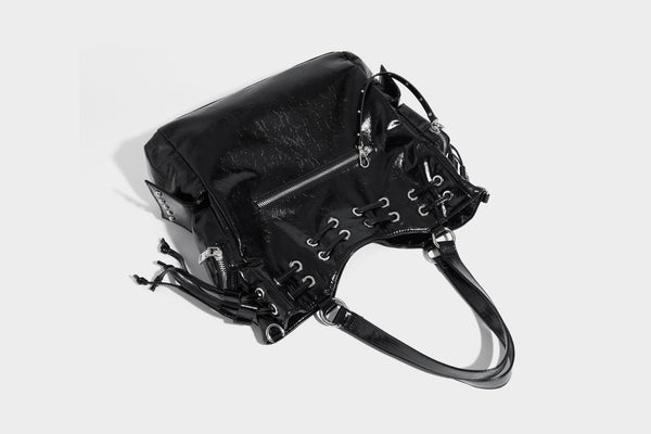 Glossy crinkled leather-look tote bag with silver grommet lace-up front detail, dual top handles, and detachable shoulder