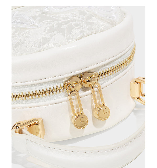 Structured mini backpack handbag with butterfly embroidery, gold-tone chain strap, and turn-lock front flap pocket, detail