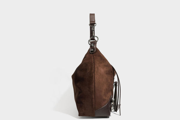 Slouchy suede-finish hobo shoulder bag with dark hardware, exterior zip pocket, tassel ties, and detachable crossbody strap