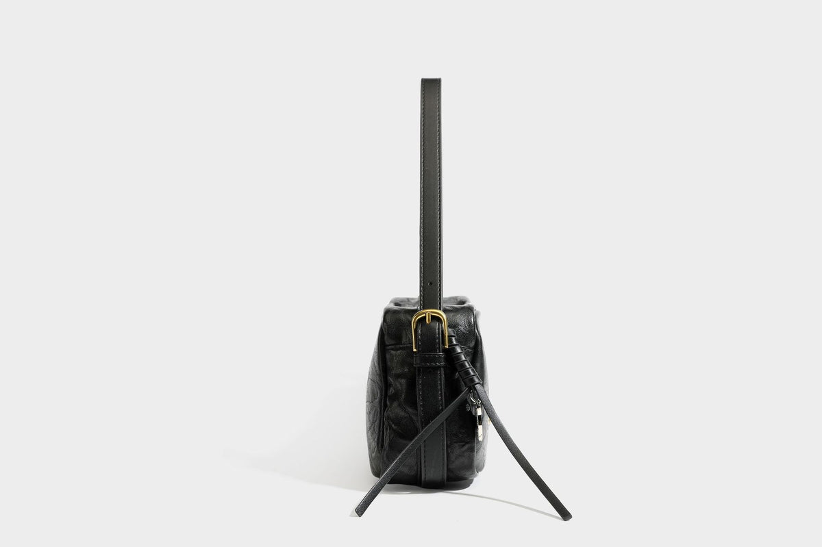 Compact black crinkled leather-look baguette shoulder bag with gold-tone arch hardware and adjustable strap, detail view 27