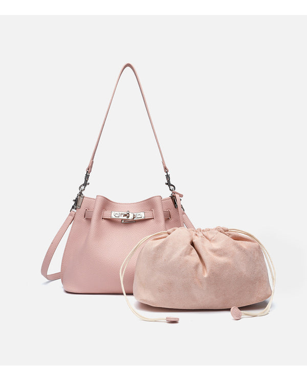 Soft-structured pebbled leather-look bucket bag with silver turn-lock front clasp and adjustable crossbody strap, detail view