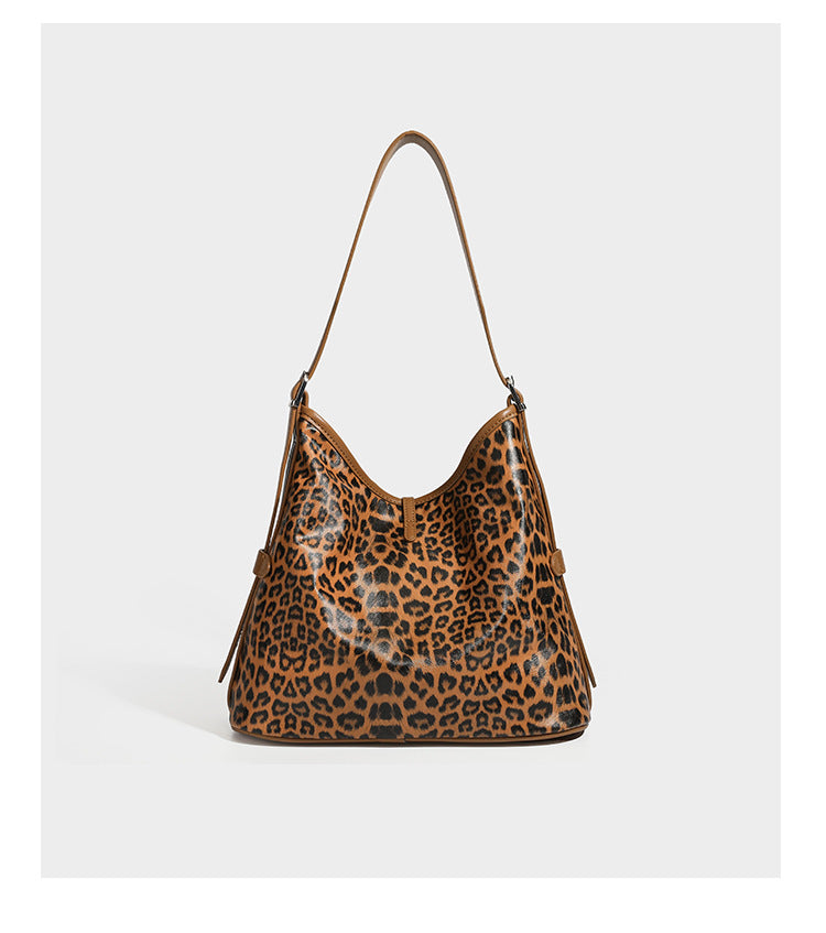 Slouchy leopard print shoulder hobo bag with black leather-look trim, tie-top closure, and single long strap, detail view 18