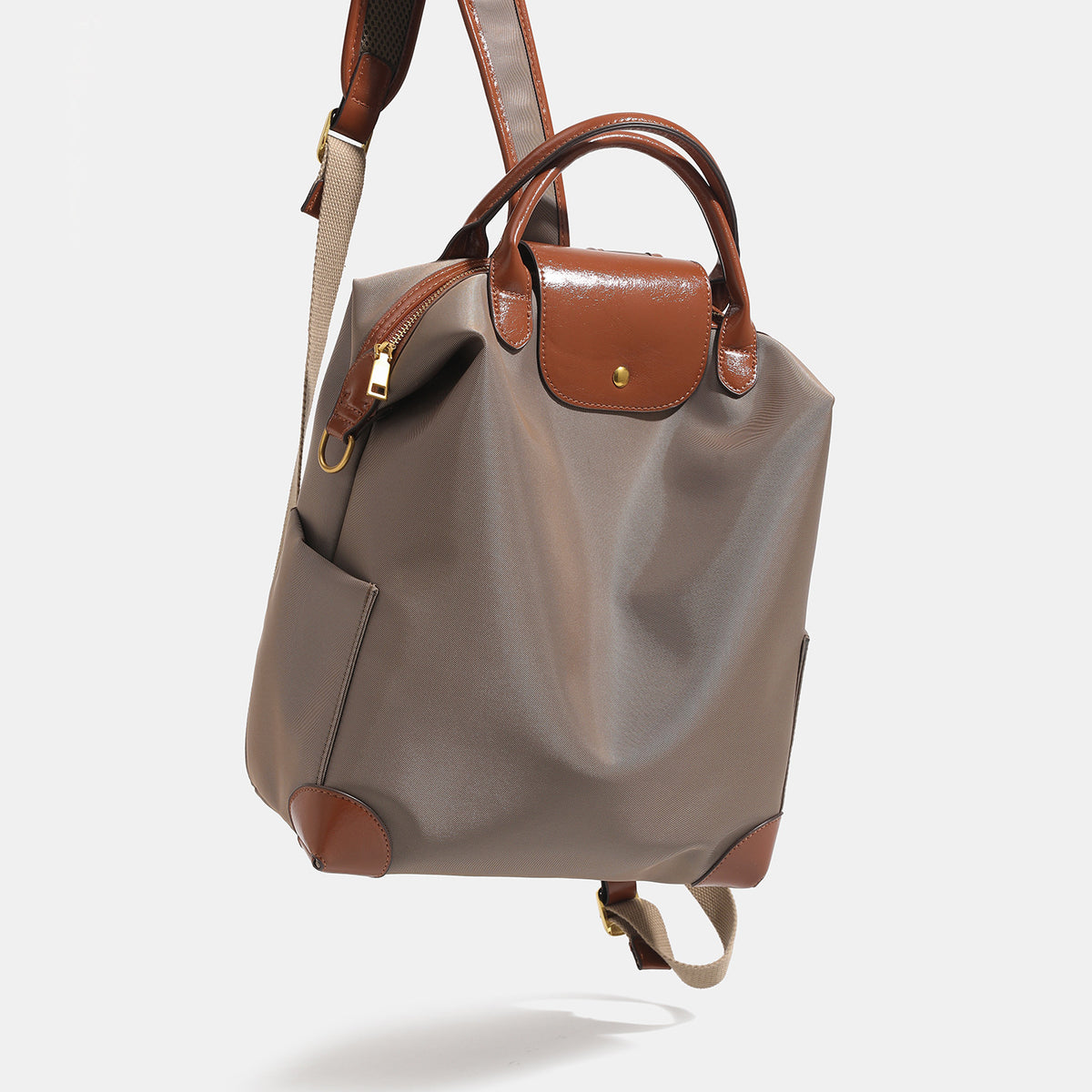 Soft rectangular nylon convertible backpack handbag with leather-look trim, snap-flap closure, top carry handles, padded