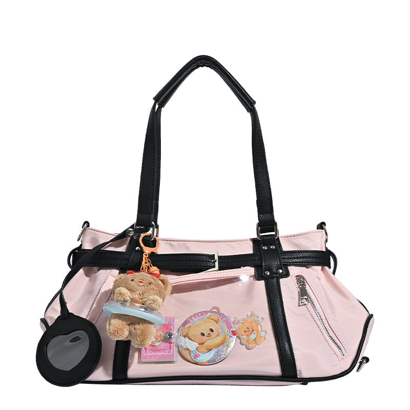 Pale pink nylon tote bag with black leather-look trim, double top handles, side zip pocket, and detachable crossbody strap