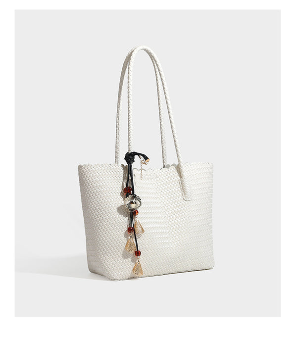 Large open-top woven leather-look tote bag in dark brown with scalloped edge, braided double shoulder straps, and decorative