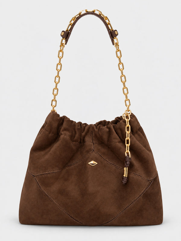 Slouchy suede-look shoulder bag with gathered top, angular stitched paneling, and chunky gold-tone chain strap, detail view