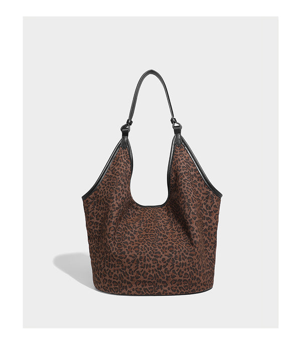 Slouchy brown leopard jacquard hobo tote bag with black leather-look trim and single shoulder strap, shown with black, detail