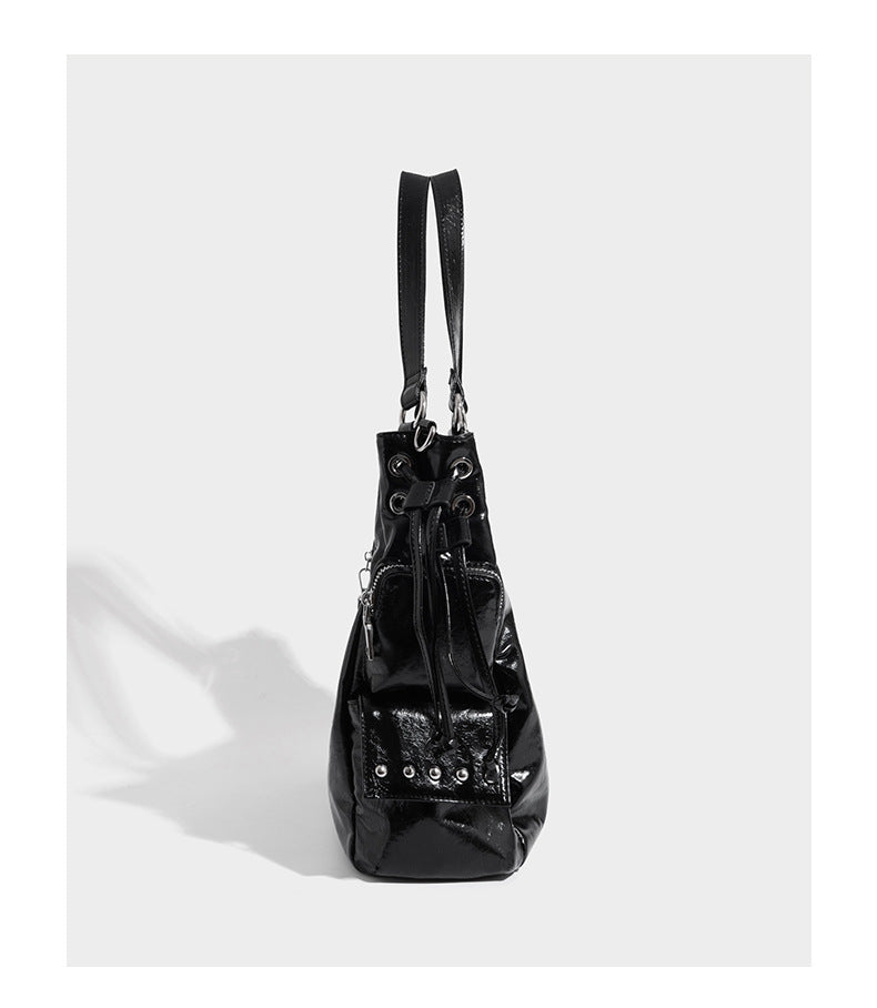 Glossy crinkled leather-look tote bag with silver grommet lace-up front detail, dual top handles, and detachable shoulder