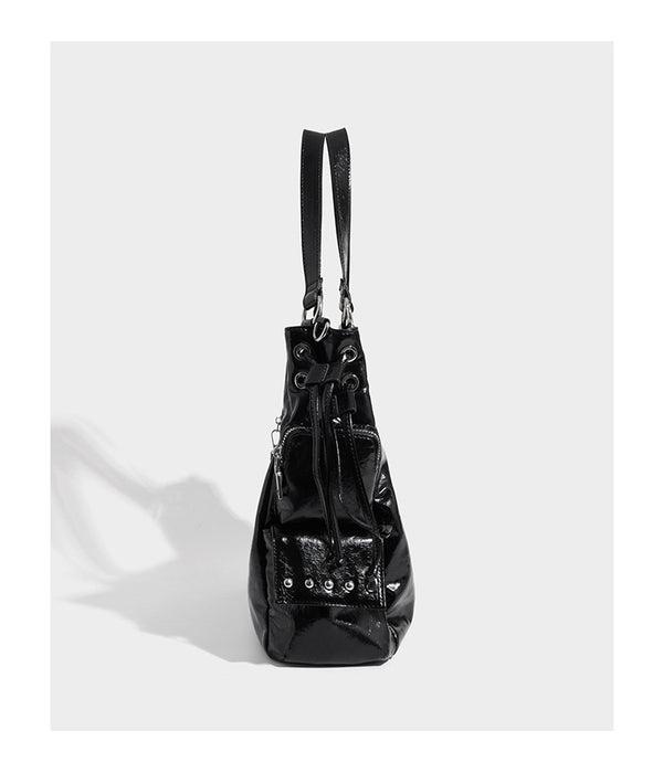Glossy crinkled leather-look tote bag with silver grommet lace-up front detail, dual top handles, and detachable shoulder