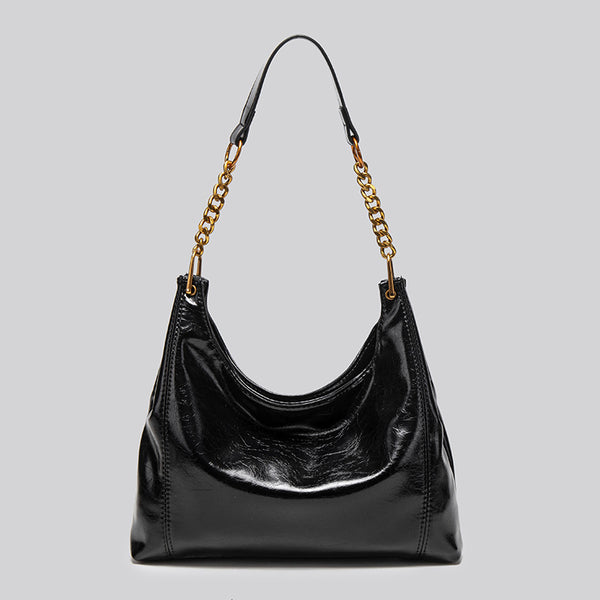 Glossy leather-look hobo shoulder bag with gold-tone chain-and-leather strap in deep burgundy red, detail view 7