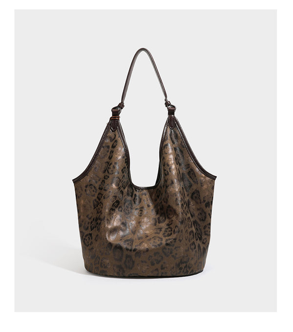 Large slouchy leopard-print shoulder tote bag with glossy tan-and-brown finish, dark brown leather-look trim, single