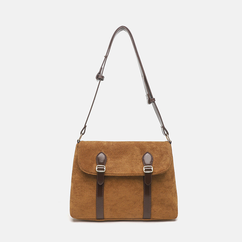 Tan suede-finish flap satchel bag with dark brown leather-look trim, buckle strap detail, and gold-tone hardware, front view