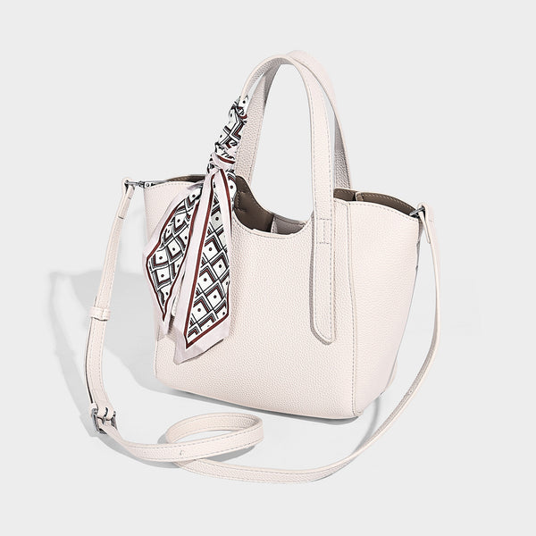 Structured pebbled leather-look tote bag with detachable scarf tie, dual top handles, and adjustable crossbody strap, detail