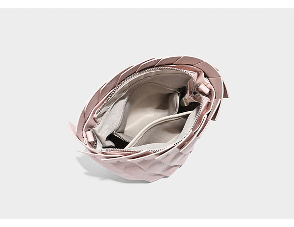 Structured pleated-panel bucket bag with curved top handle and detachable adjustable shoulder strap in smooth matte, detail